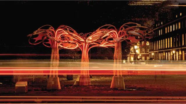 The illuminated rattan pavilion photographed at night.